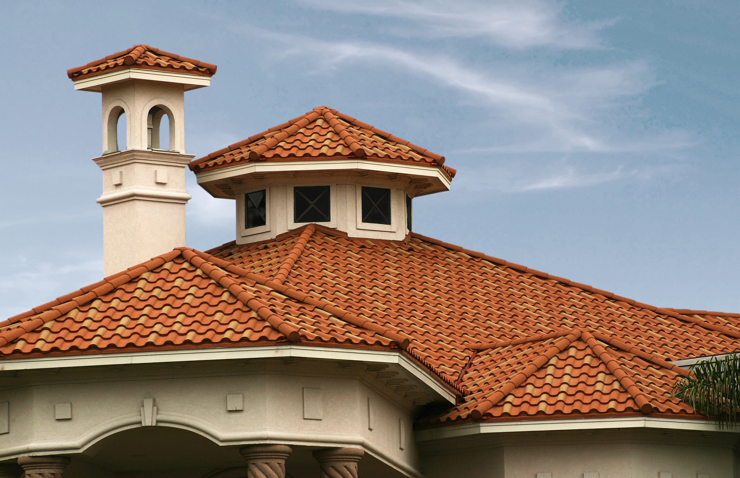 Elegant stone-coated metal roof tiles on a stylish home, highlighting the textured, durable surface.