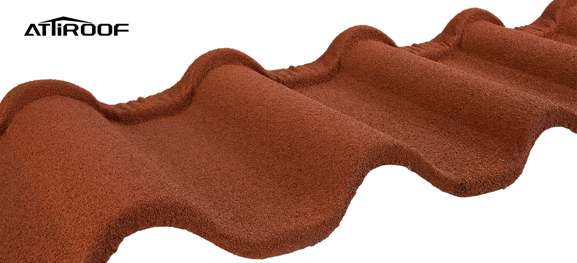 Close-up of a stone-coated roofing tile showing the rich terracotta color and textured surface detail.