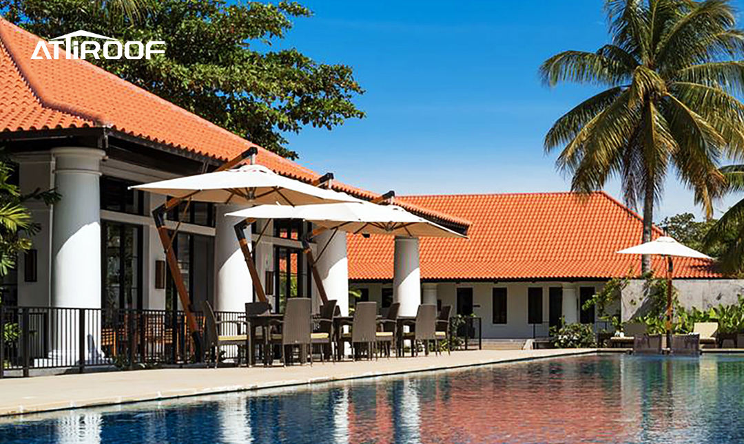 Luxurious resort poolside area with Attiroof's terracotta stone-coated tiles perfectly complementing the historical architectural style of the hotel.