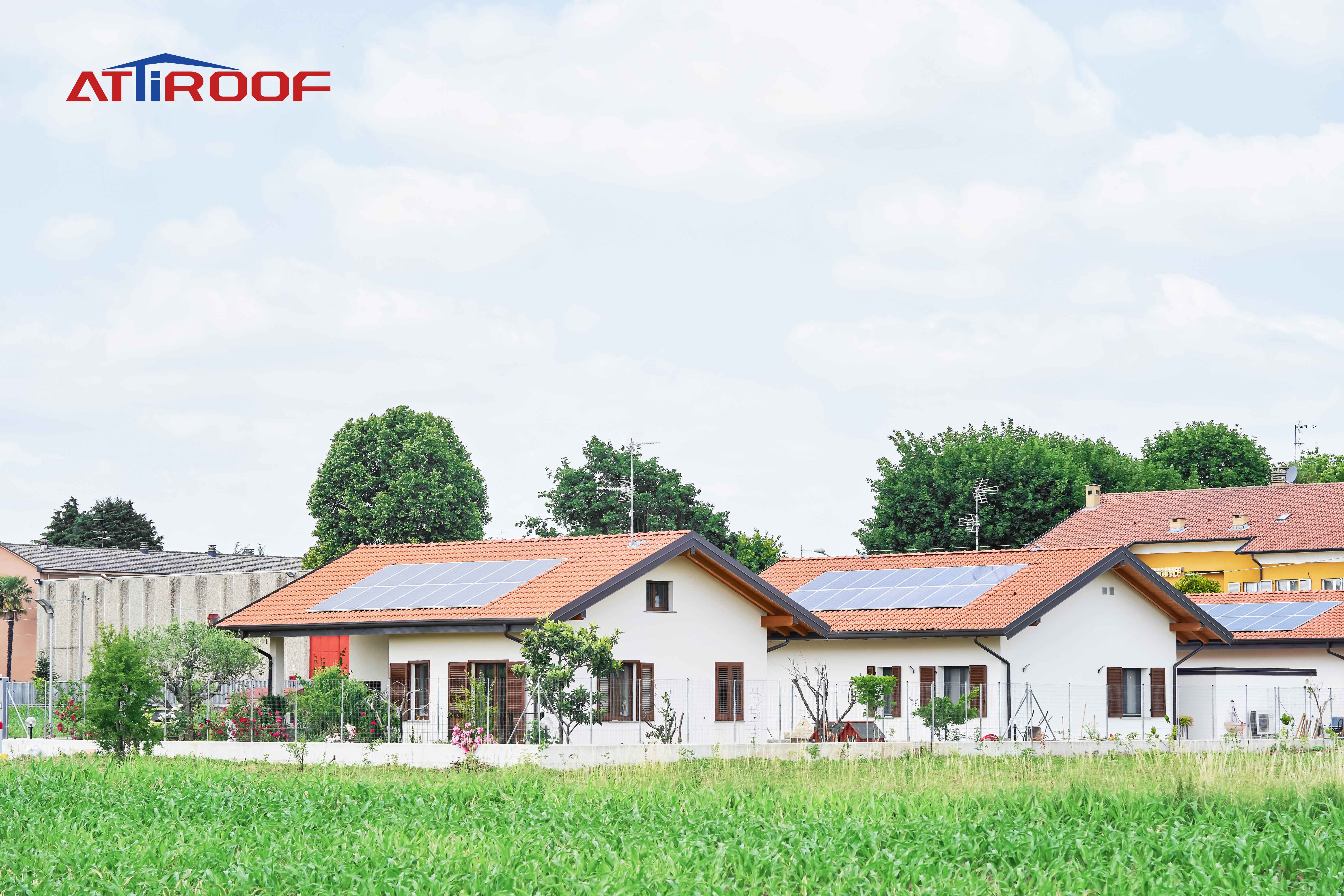 Houses with synthetic resin roof tiles and solar panels, showcasing a real-world example of integrating renewable energy solutions with modern roofing materials.