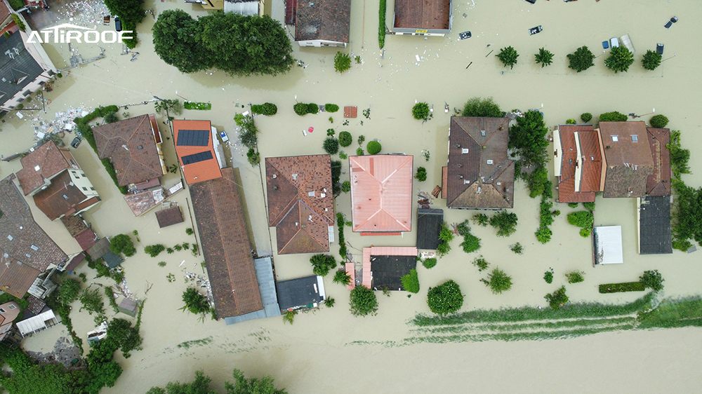 Aerial view of flooded homes, showcasing the resilience of Atiroof's stone-coated metal roofs in high-wind and extreme weather conditions.