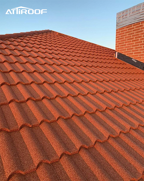 Close-up of stone-coated metal roof tiles showcasing their reflective properties, highlighting eco-friendly roof tiles.