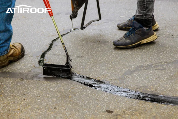 Filling cracks with asphalt for Asphalt Shingles maintenance.