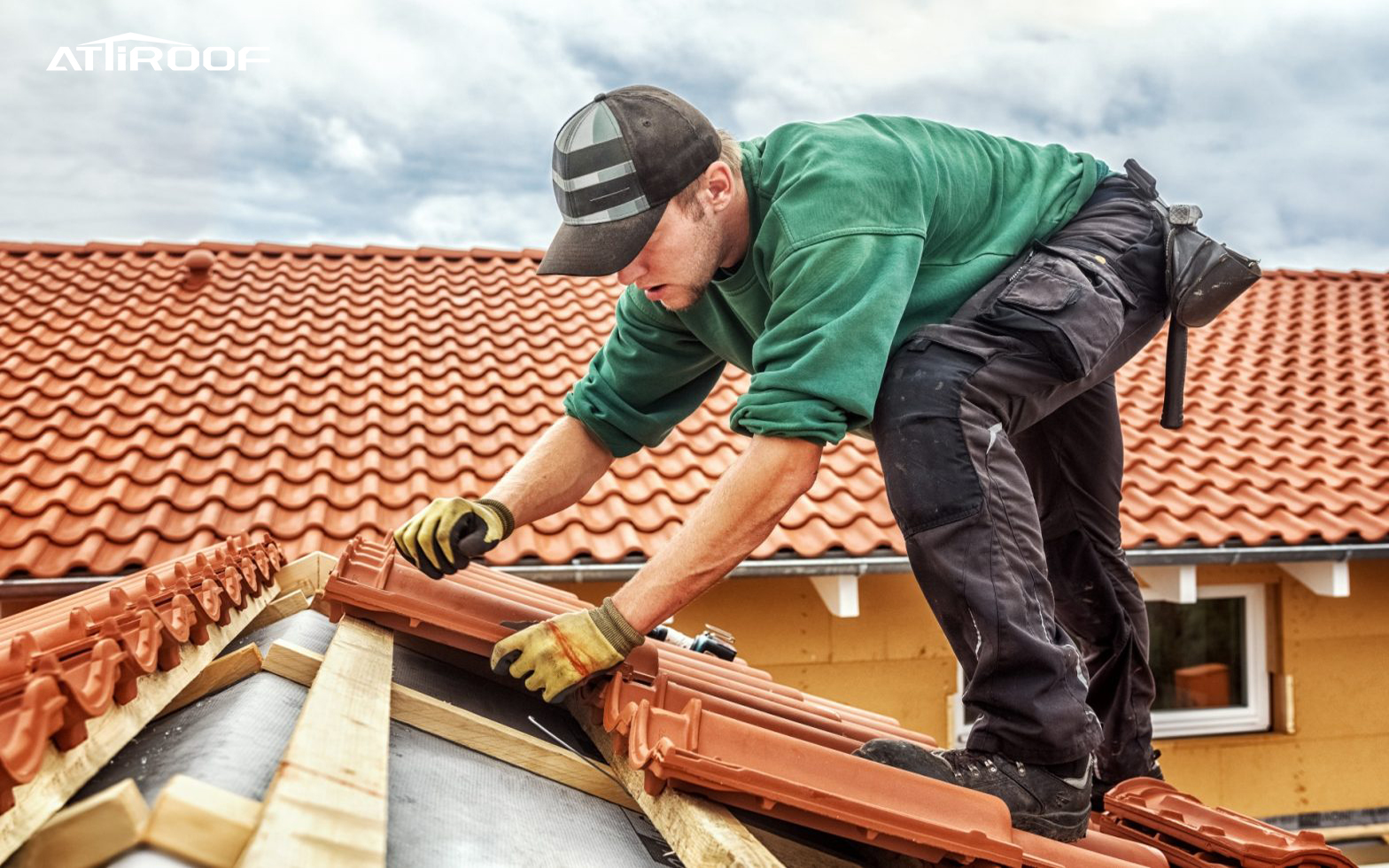 Professional contractor installing red roof tiles. Keywords: Roof Tiles Design.