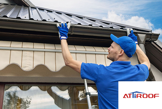 Professional installing cool roof tiles on a house. Cool roof tiles for better energy efficiency.