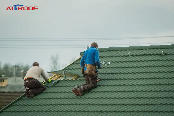 Professional workers installing stone-coated metal roof tiles, ensuring durability and aesthetic appeal for residential homes.